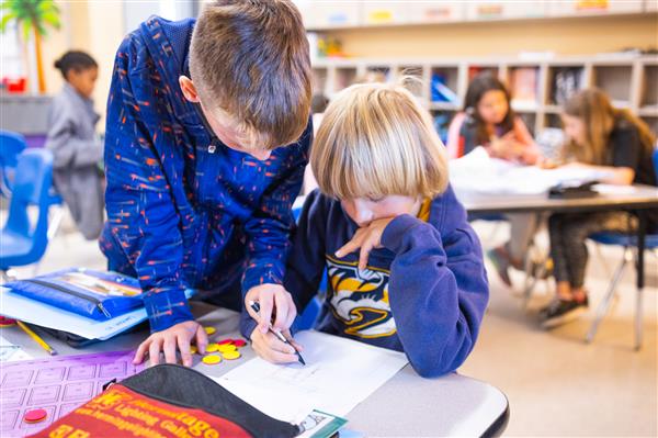 Students inside their classrooms learning. 